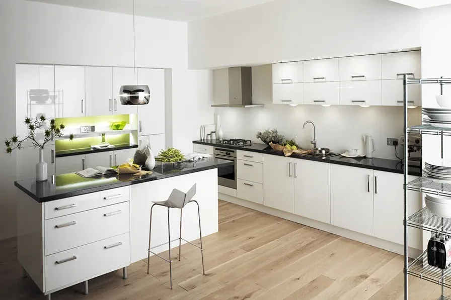 Modern kitchen with white cabinetry and black countertops Modern kitchen with white cabinetry and black countertops