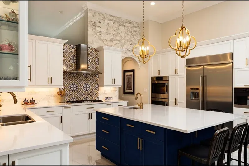 Modern kitchen with white cabinetry, blue island