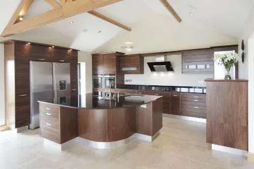 Modern kitchen with wooden cabinets, a sleek black countertop