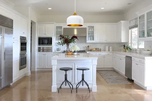 Modern white kitchen with stainless steel appliances