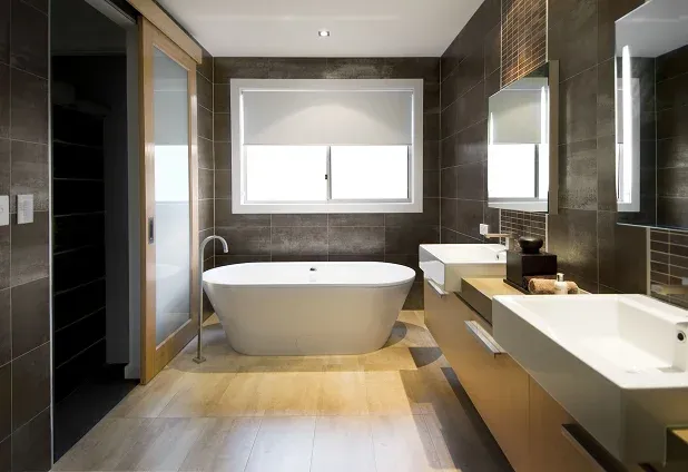 bathroom with bathtub sinks and window bathroom with bathtub, sinks, and window