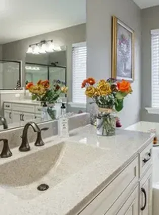 bathroom with flowers sink and mirror bathroom with flowers, sink, and mirror