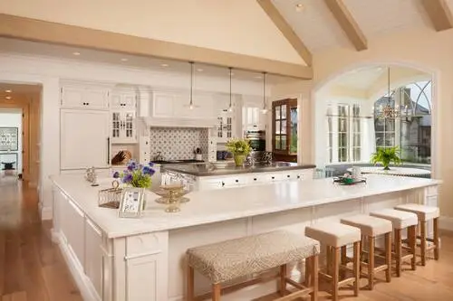 kitchen with white cabinetry and island seating